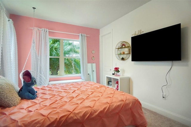 carpeted bedroom featuring baseboards