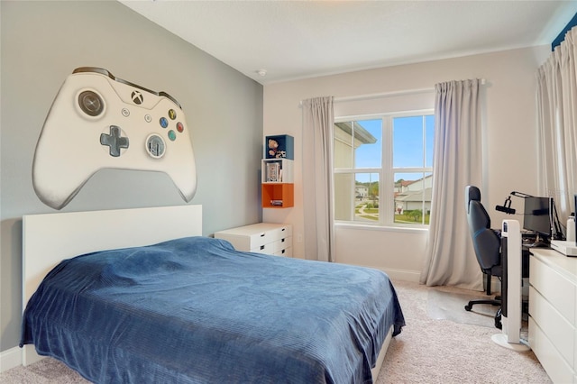 bedroom featuring light carpet and baseboards