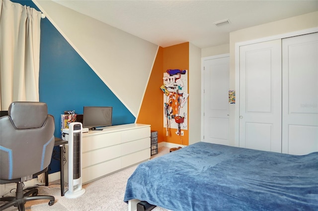 bedroom featuring baseboards, a closet, visible vents, and carpet flooring