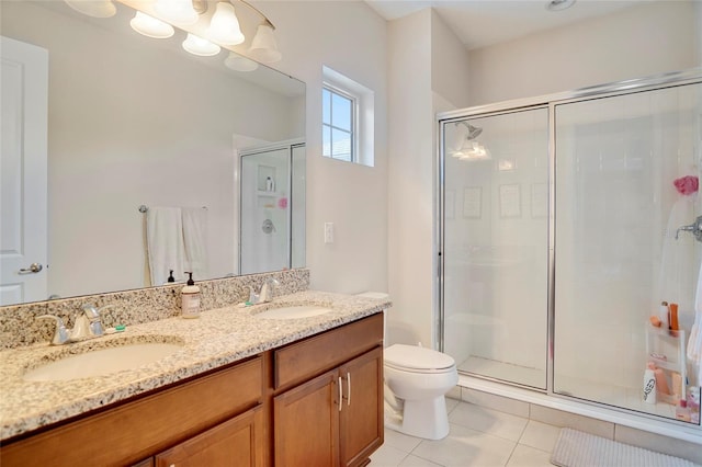 bathroom with a stall shower, a sink, and tile patterned floors