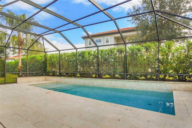 view of swimming pool featuring a lanai and a patio area