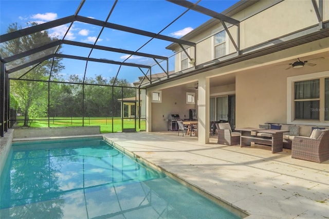 pool featuring ceiling fan, a patio, glass enclosure, and an outdoor living space