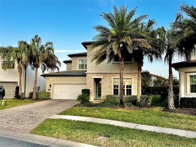 view of front facade featuring a garage and a front lawn