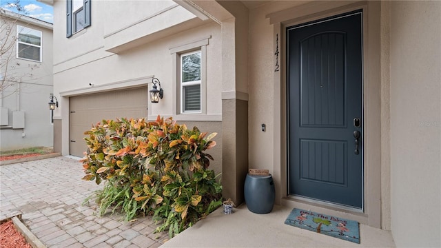 view of exterior entry featuring a garage