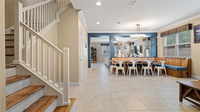 dining space featuring an inviting chandelier and ornamental molding