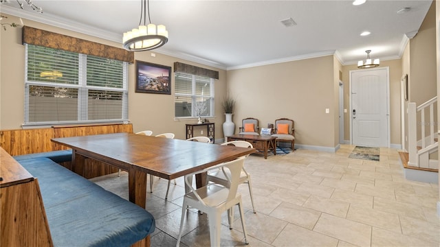 dining space featuring ornamental molding and light tile patterned floors