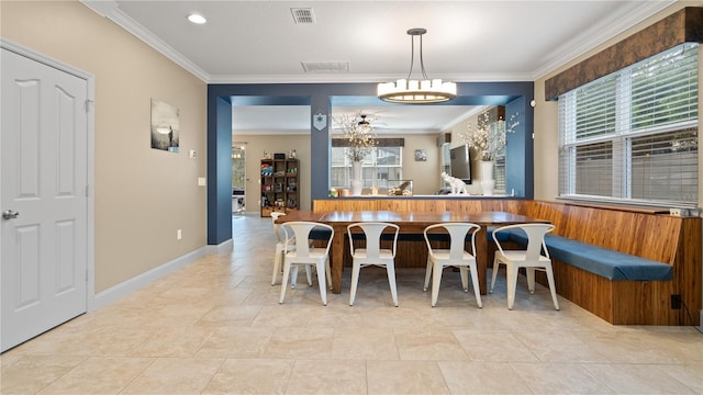 dining space with a notable chandelier, crown molding, and a wealth of natural light