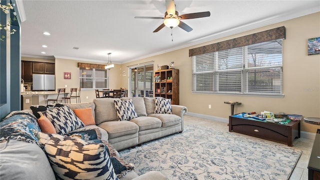 living room with ornamental molding, ceiling fan, and light tile patterned flooring