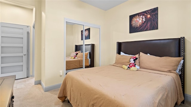 bedroom featuring light carpet and a closet