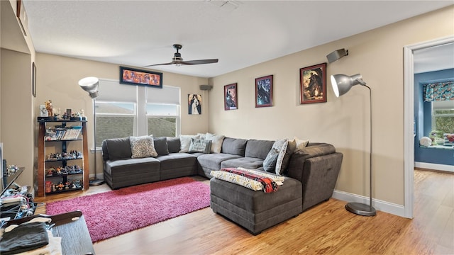 living room featuring hardwood / wood-style flooring and ceiling fan