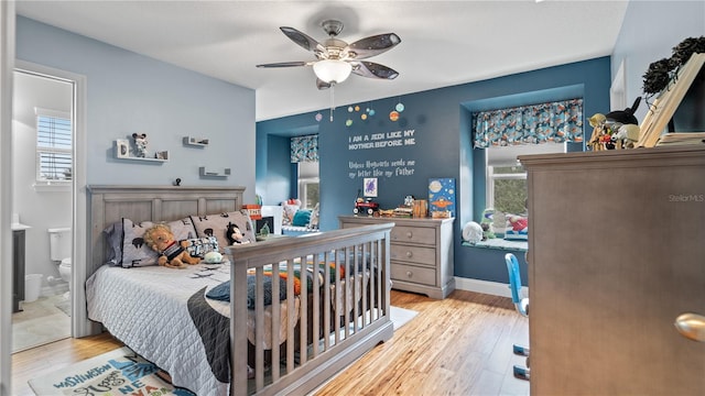 bedroom featuring ceiling fan, connected bathroom, and light wood-type flooring