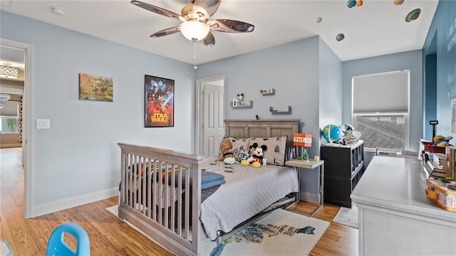 bedroom with light hardwood / wood-style floors and ceiling fan