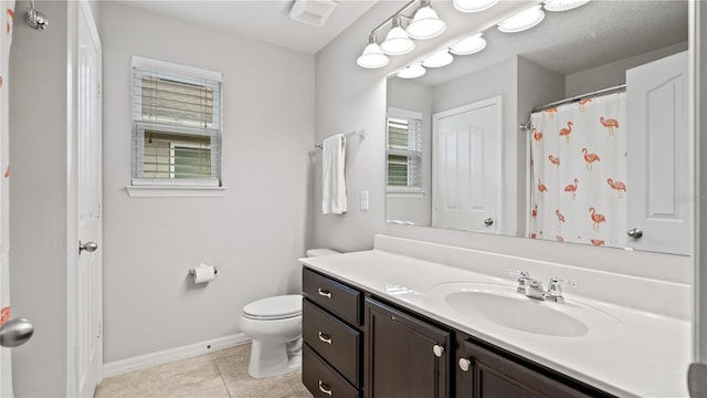 bathroom with vanity, toilet, and tile patterned flooring