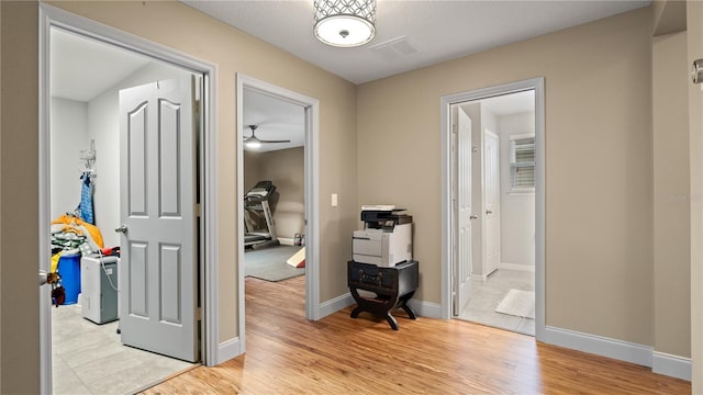 corridor with light hardwood / wood-style flooring