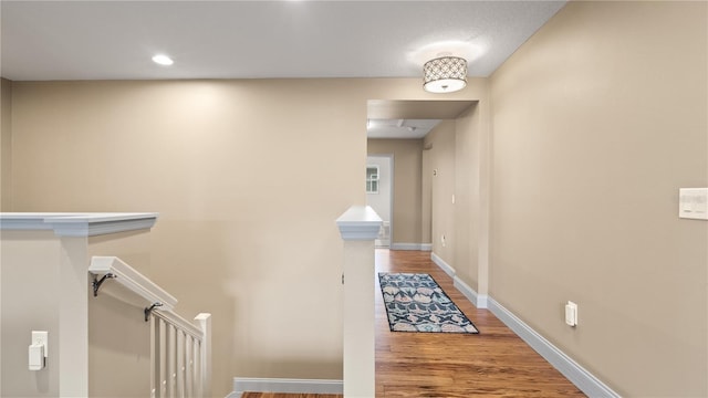 hall with hardwood / wood-style floors