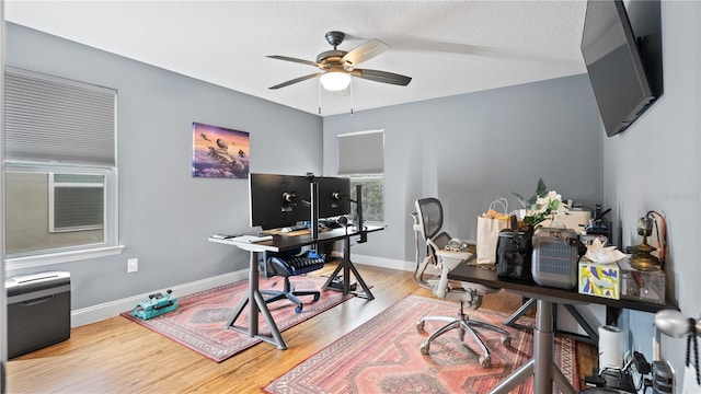 home office featuring hardwood / wood-style floors and ceiling fan