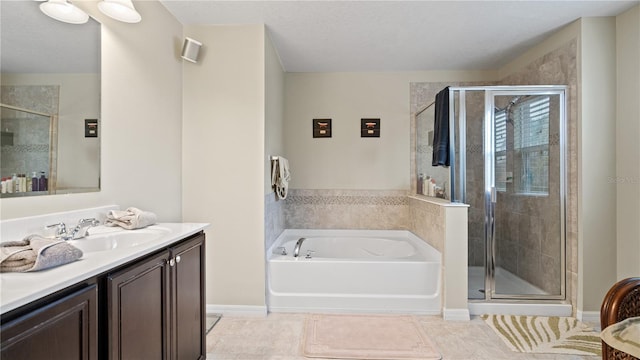 bathroom featuring tile patterned flooring, vanity, and separate shower and tub