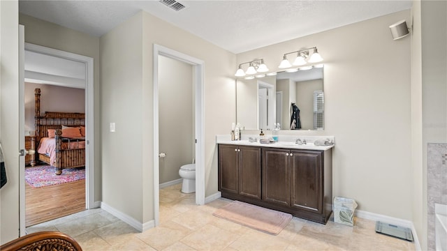 bathroom with tile patterned floors, vanity, and toilet