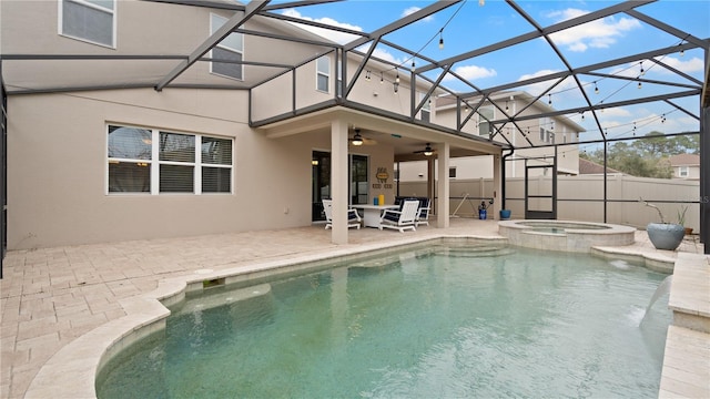 view of pool with an in ground hot tub, a lanai, ceiling fan, and a patio