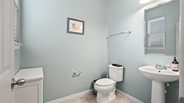 bathroom featuring tile patterned flooring, sink, and toilet