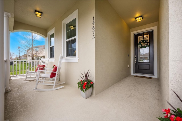 view of exterior entry featuring a porch