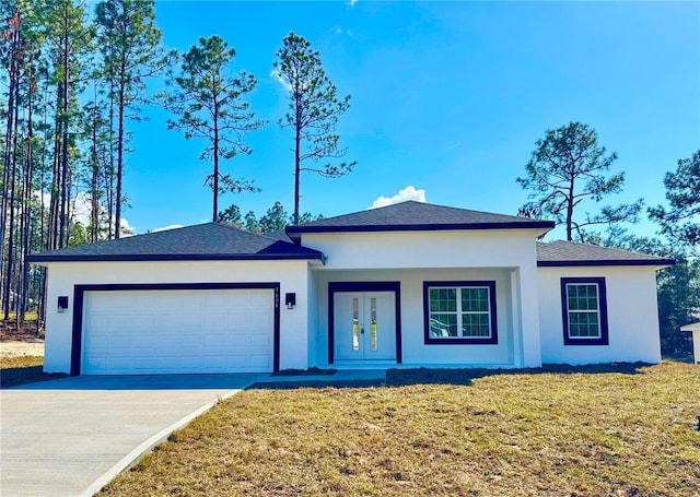 view of front of house with a garage and a front lawn