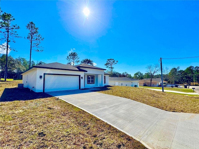 single story home featuring a garage and a front lawn