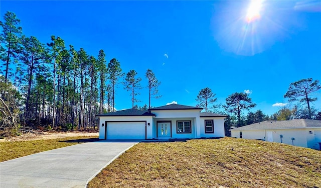 ranch-style home with a front lawn and a garage