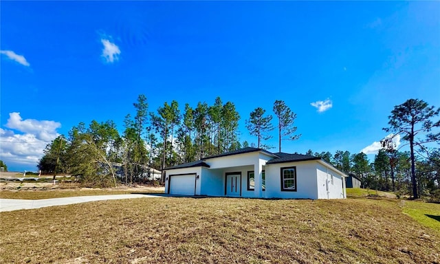 view of front of property with a garage and a front yard