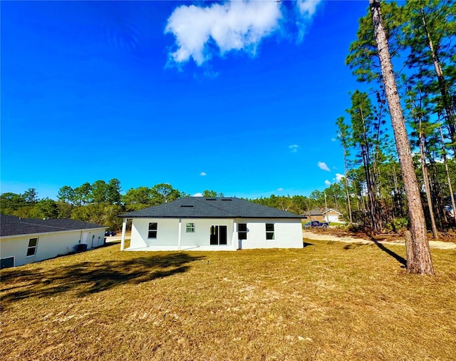 rear view of property featuring a yard