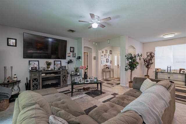 tiled living room with ceiling fan