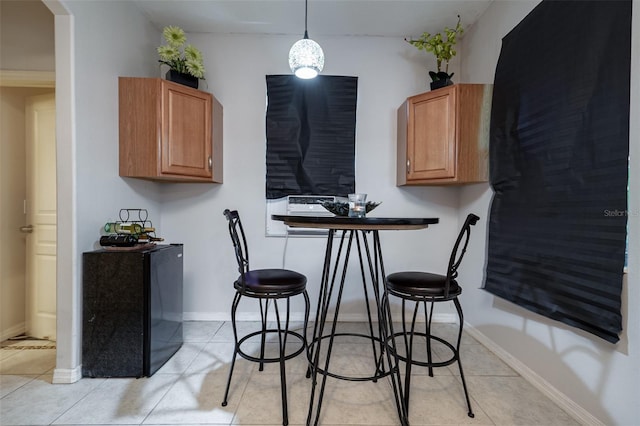 kitchen featuring hanging light fixtures, a breakfast bar area, and light tile patterned flooring