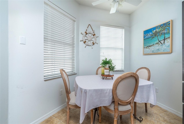 tiled dining room featuring ceiling fan