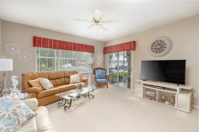 carpeted living room with ceiling fan