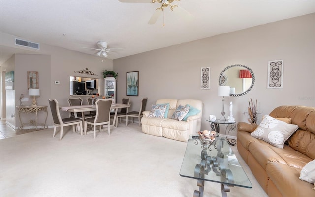 carpeted living room featuring ceiling fan