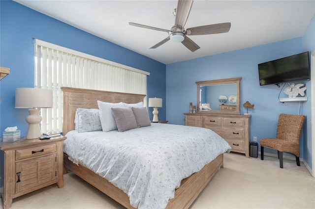 bedroom with light carpet and ceiling fan