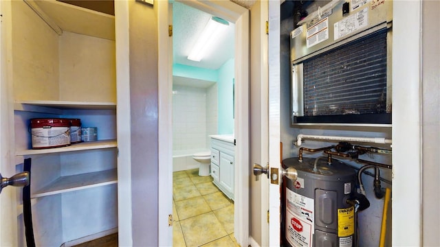 bathroom with tile patterned flooring, water heater, and toilet