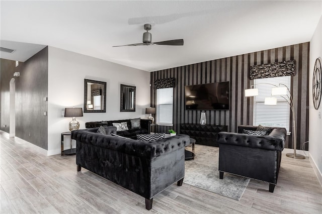 living room with ceiling fan and light hardwood / wood-style flooring