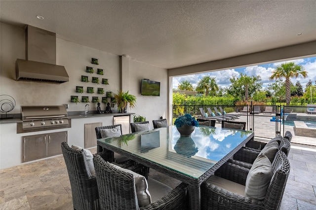 view of patio with an outdoor kitchen, sink, and grilling area