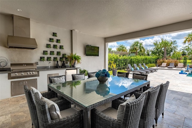 view of patio featuring a grill, sink, and exterior kitchen