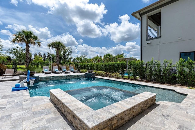 view of pool featuring an in ground hot tub, pool water feature, and a patio