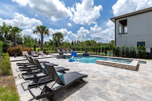 view of swimming pool featuring pool water feature, an in ground hot tub, and a patio