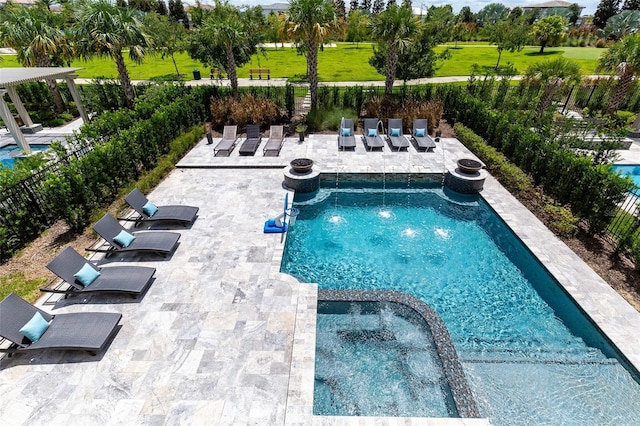 view of pool with a fire pit and a patio