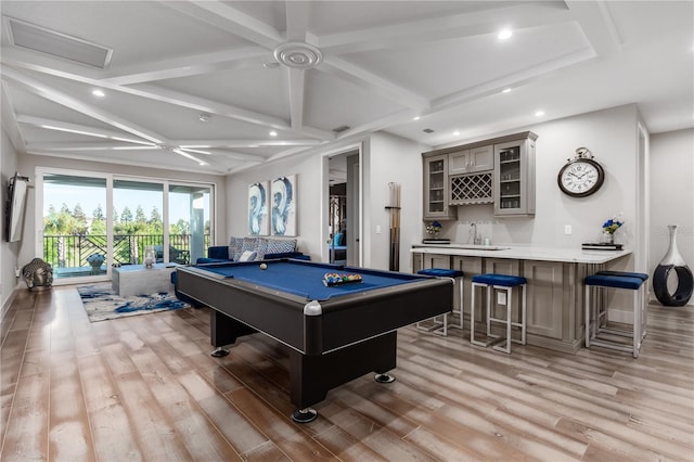 rec room featuring beam ceiling, bar, pool table, and light hardwood / wood-style flooring