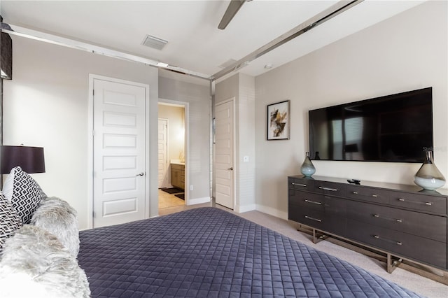 carpeted bedroom with ceiling fan and ensuite bath