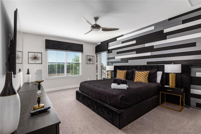 carpeted bedroom with ceiling fan and a textured ceiling