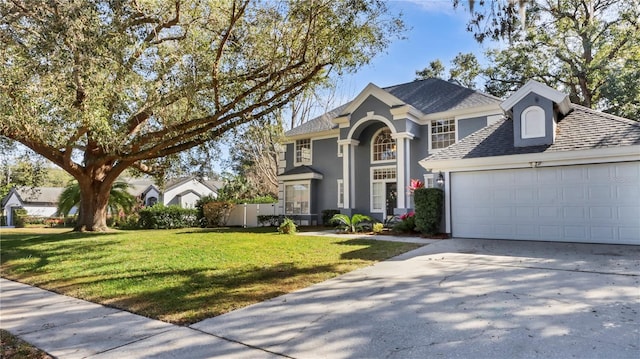 front facade featuring a garage and a front yard