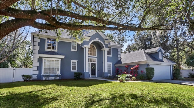 view of front of property featuring a garage and a front yard