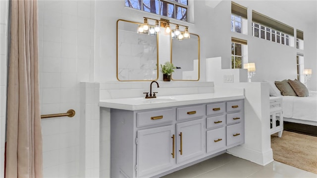 bathroom with vanity, tile patterned floors, and a high ceiling