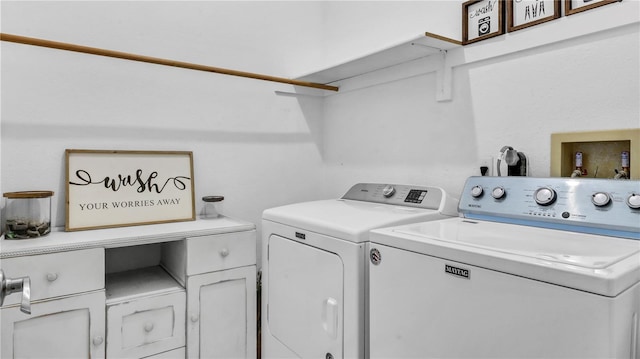 clothes washing area featuring cabinets and independent washer and dryer